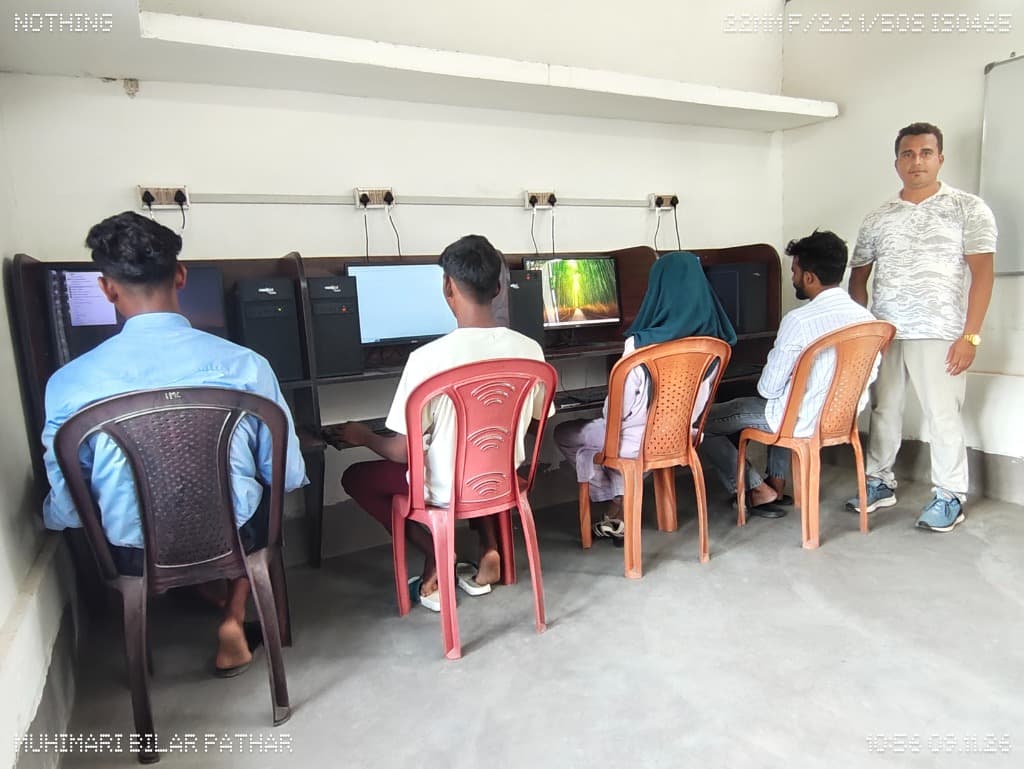 Students actively practicing on desktop workstations at Internet Zone computer lab